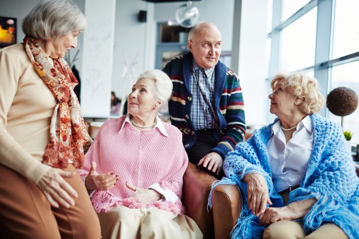 Aged adults having conversation indoors